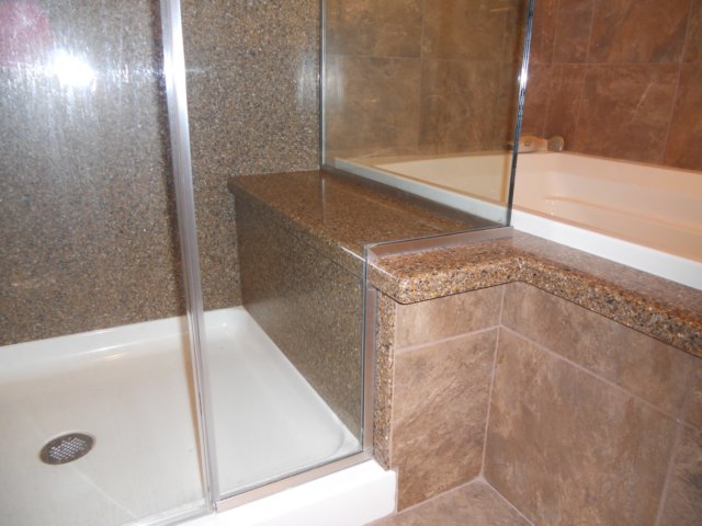 solidsurfaceshowercustomglassenclosure.jpg